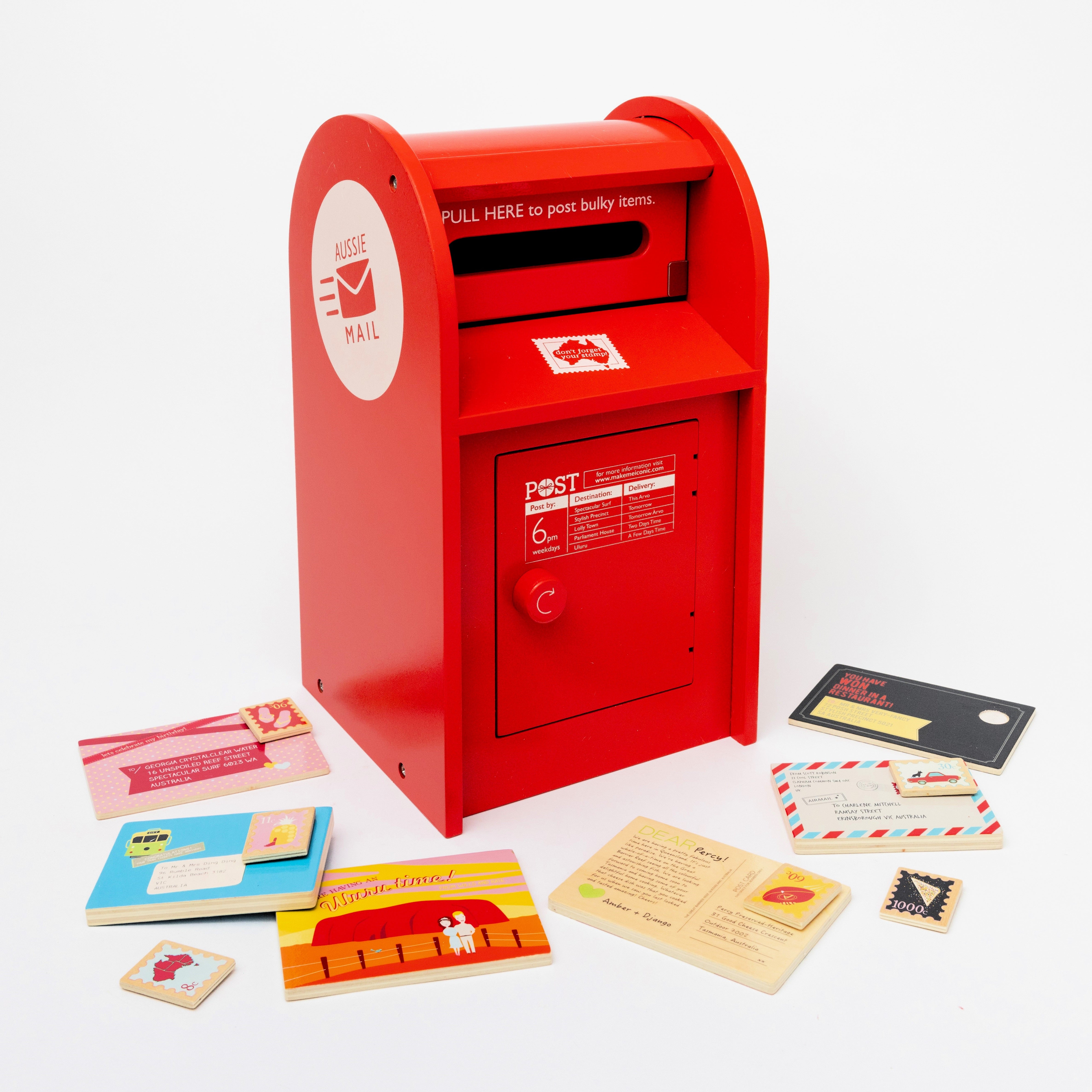 Make Me Iconic 13-piece wooden toy Post Box set with working slot, Velcro stamps, and envelopes—perfect for pretend mail play and developing fine motor skills.