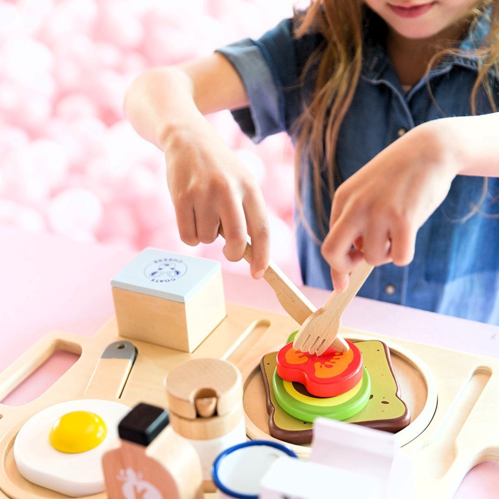 21-piece wooden toy breakfast tray featuring avocado on toast, goats cheese, tahini, kombucha, and other café-style foods for pretend play fun.