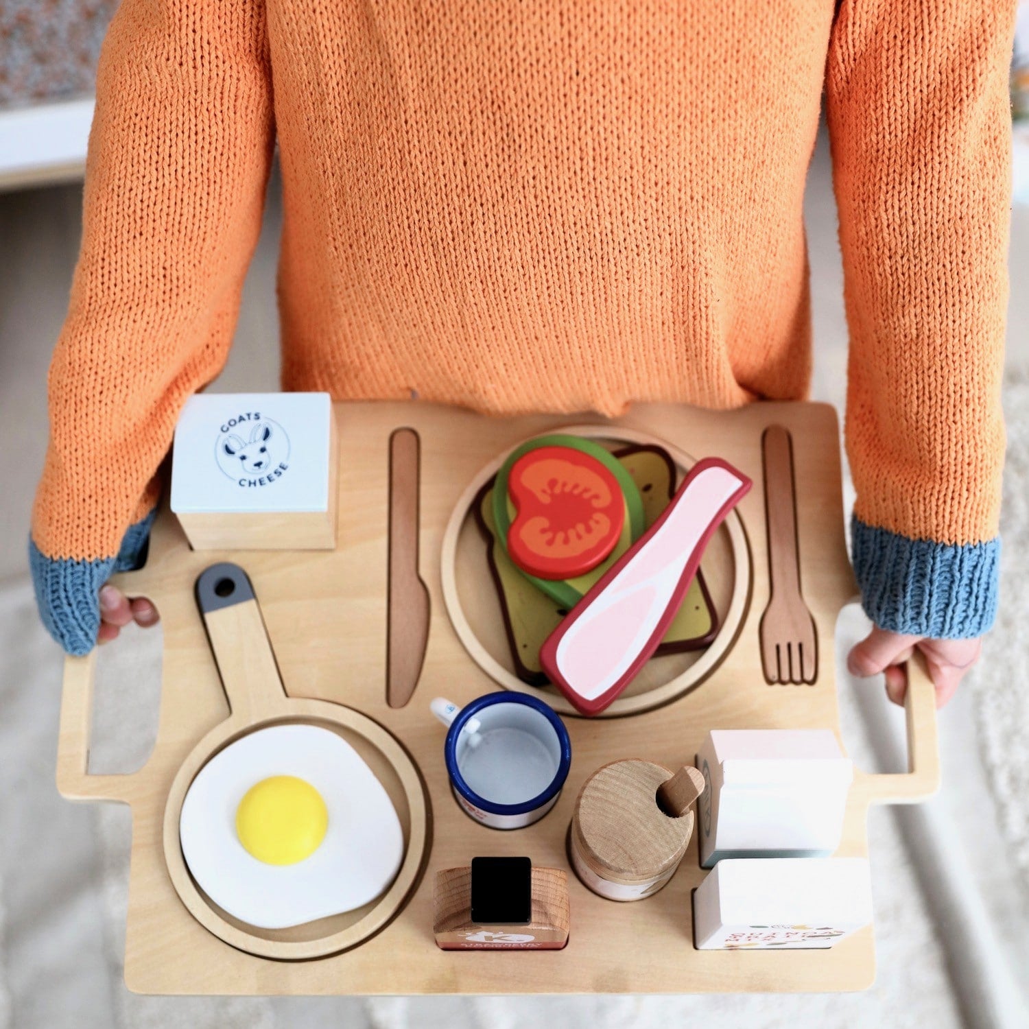 21-piece wooden toy breakfast tray featuring avocado on toast, goats cheese, tahini, kombucha, and other café-style foods for pretend play fun.