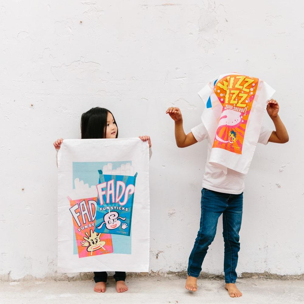 Retro Fads Fun Sticks tea towel made from 100% cotton, featuring nostalgic Australian candy design, perfect for gifting, kitchen décor, and Aussie souvenirs.