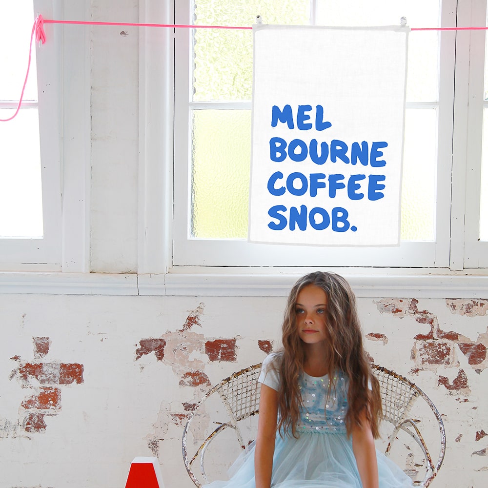 Make Me Iconic Coffee Snob Tea Towel celebrating Melbourne’s coffee culture, as featured by Kylie Minogue on Instagram, perfect for caffeine lovers and city pride.