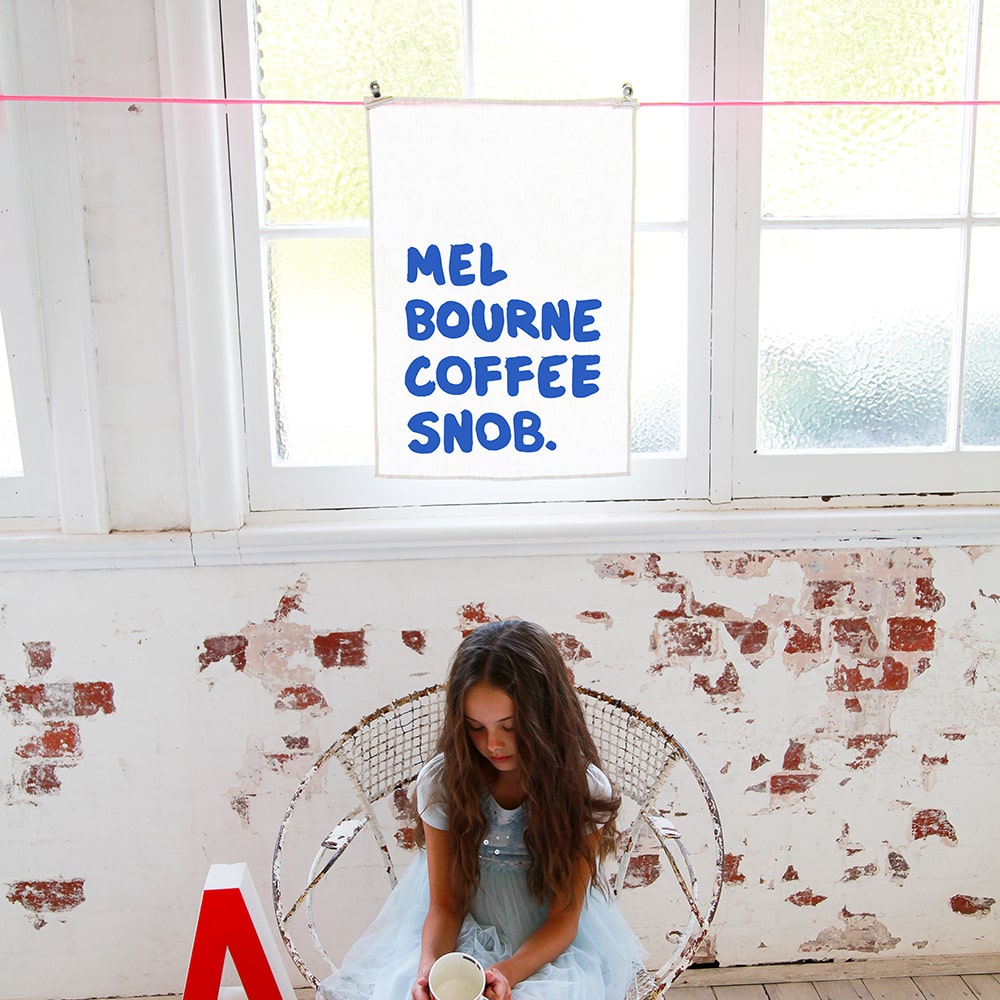 Make Me Iconic Coffee Snob Tea Towel celebrating Melbourne’s coffee culture, as featured by Kylie Minogue on Instagram, perfect for caffeine lovers and city pride.