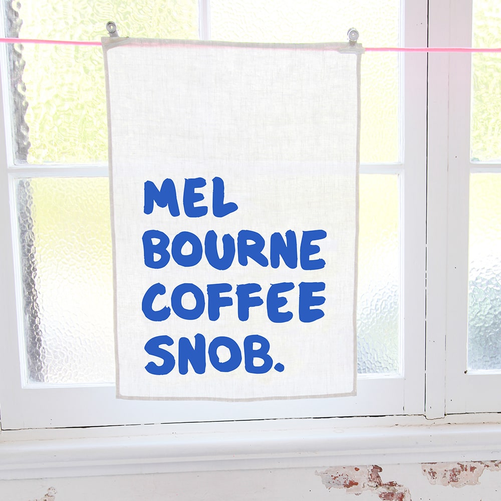 Make Me Iconic Coffee Snob Tea Towel celebrating Melbourne’s coffee culture, as featured by Kylie Minogue on Instagram, perfect for caffeine lovers and city pride.