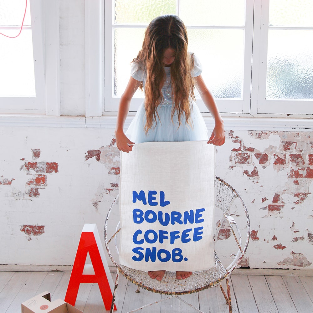 Make Me Iconic Coffee Snob Tea Towel celebrating Melbourne’s coffee culture, as featured by Kylie Minogue on Instagram, perfect for caffeine lovers and city pride.