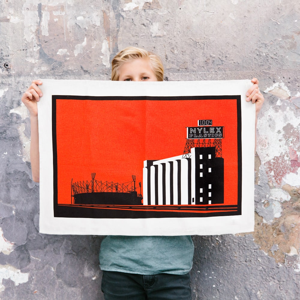 Make Me Iconic Nylex Tea Towel featuring Melbourne’s iconic rooftop sign, a tribute to vintage industrial charm and classic Aussie design.