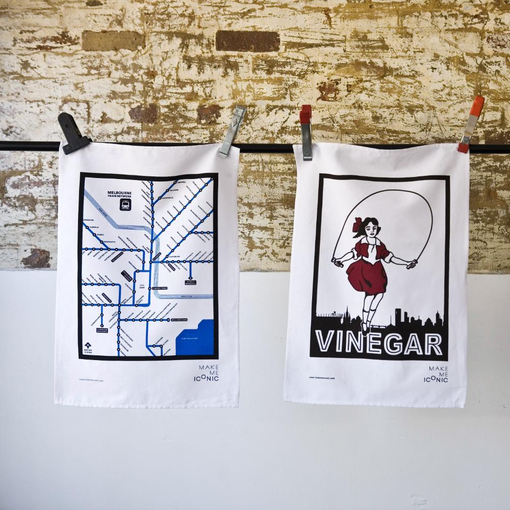 Make Me Iconic Melbourne Train Network Tea Towel featuring an illustrated map of Melbourne’s railway system, an Australian souvenir celebrating iconic public transport.