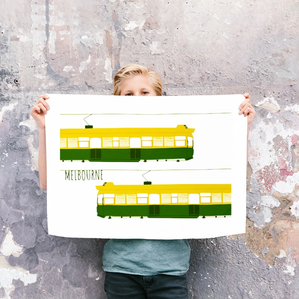 Make Me Iconic Melbourne Tram Tea Towel featuring the classic green and gold W-Class tram with vintage destination banner, an iconic Australian gift and kitchen textile.