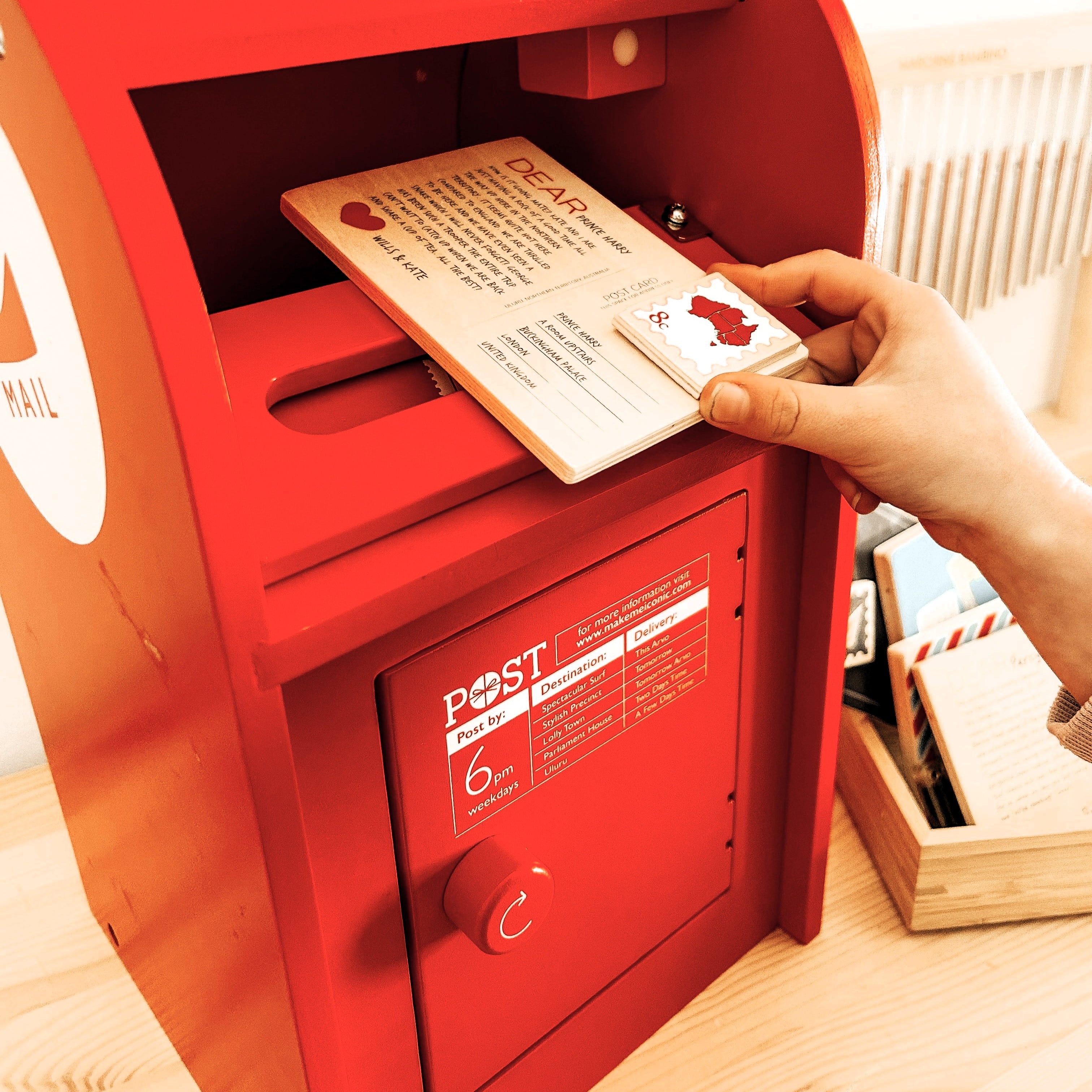 Wooden Australian post box toy with working mail slot, 6 wooden letters, and 6 Velcro stamps perfect for imaginative pretend play and storytelling.