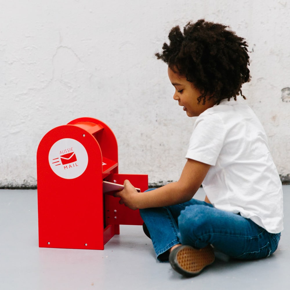 Wooden Australian post box toy with working mail slot, 6 wooden letters, and 6 Velcro stamps perfect for imaginative pretend play and storytelling.
