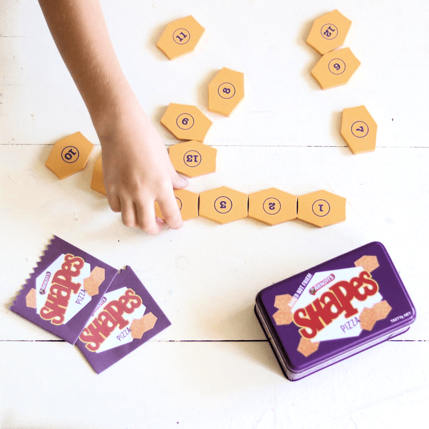 Australian Arnott’s Shapes set wooden toy with Barbecue, Pizza, and Chicken Crimpy biscuits, matching games, counting activities, and mini paper bags for pretend play.