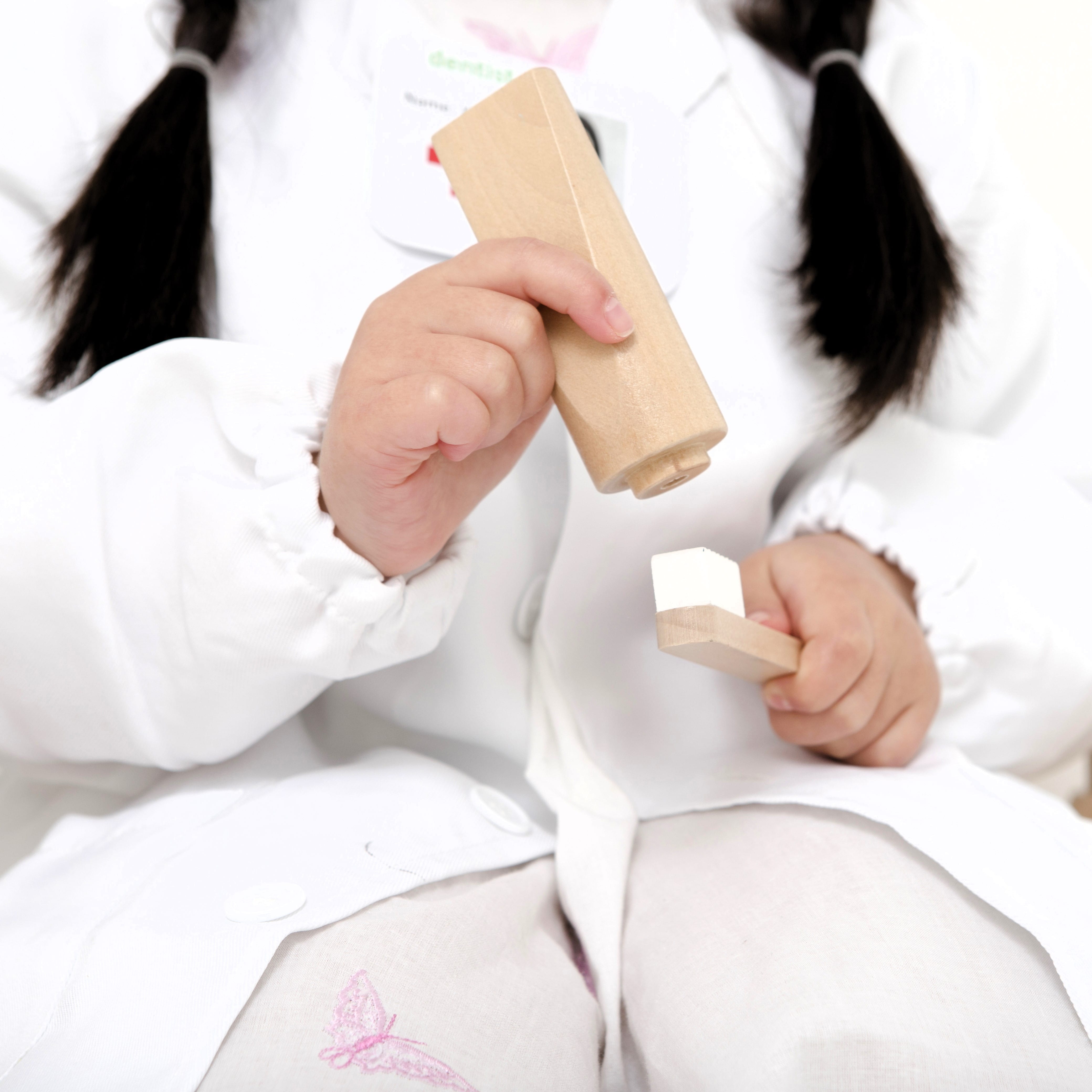 Wooden toy dentist kit with model mouth, removable teeth, dental tools, and carry box for imaginative pretend play