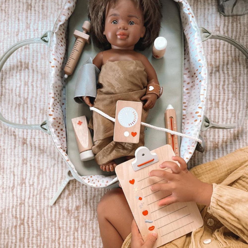 Make Me Iconic wooden Doctor’s Kit for kids, gender-neutral pretend play set with real wooden tools including stethoscope, syringe, and thermometer. Encourages imaginative play, empathy, and role-playing for young doctors and nurses.