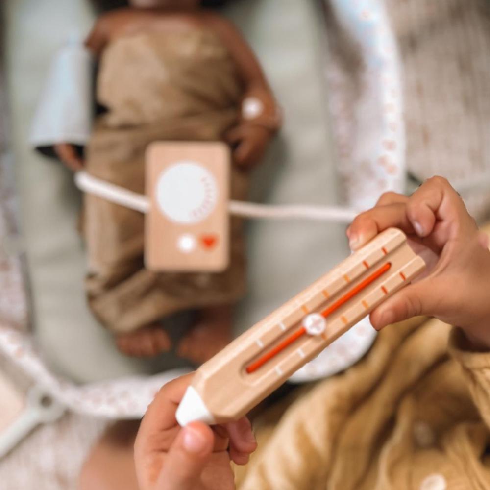Make Me Iconic wooden Doctor’s Kit for kids, gender-neutral pretend play set with real wooden tools including stethoscope, syringe, and thermometer. Encourages imaginative play, empathy, and role-playing for young doctors and nurses.