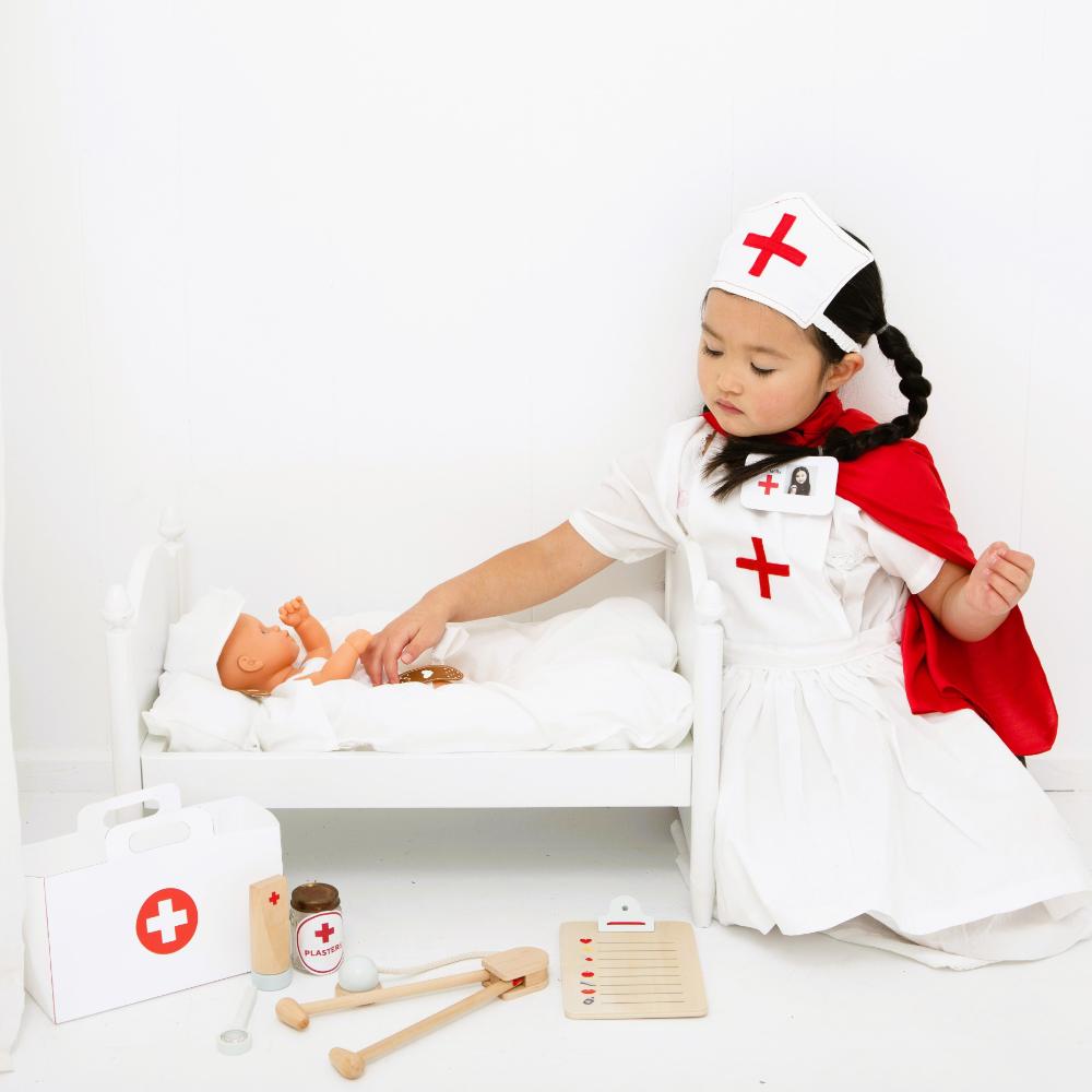 Make Me Iconic wooden Doctor’s Kit for kids, gender-neutral pretend play set with real wooden tools including stethoscope, syringe, and thermometer. Encourages imaginative play, empathy, and role-playing for young doctors and nurses.