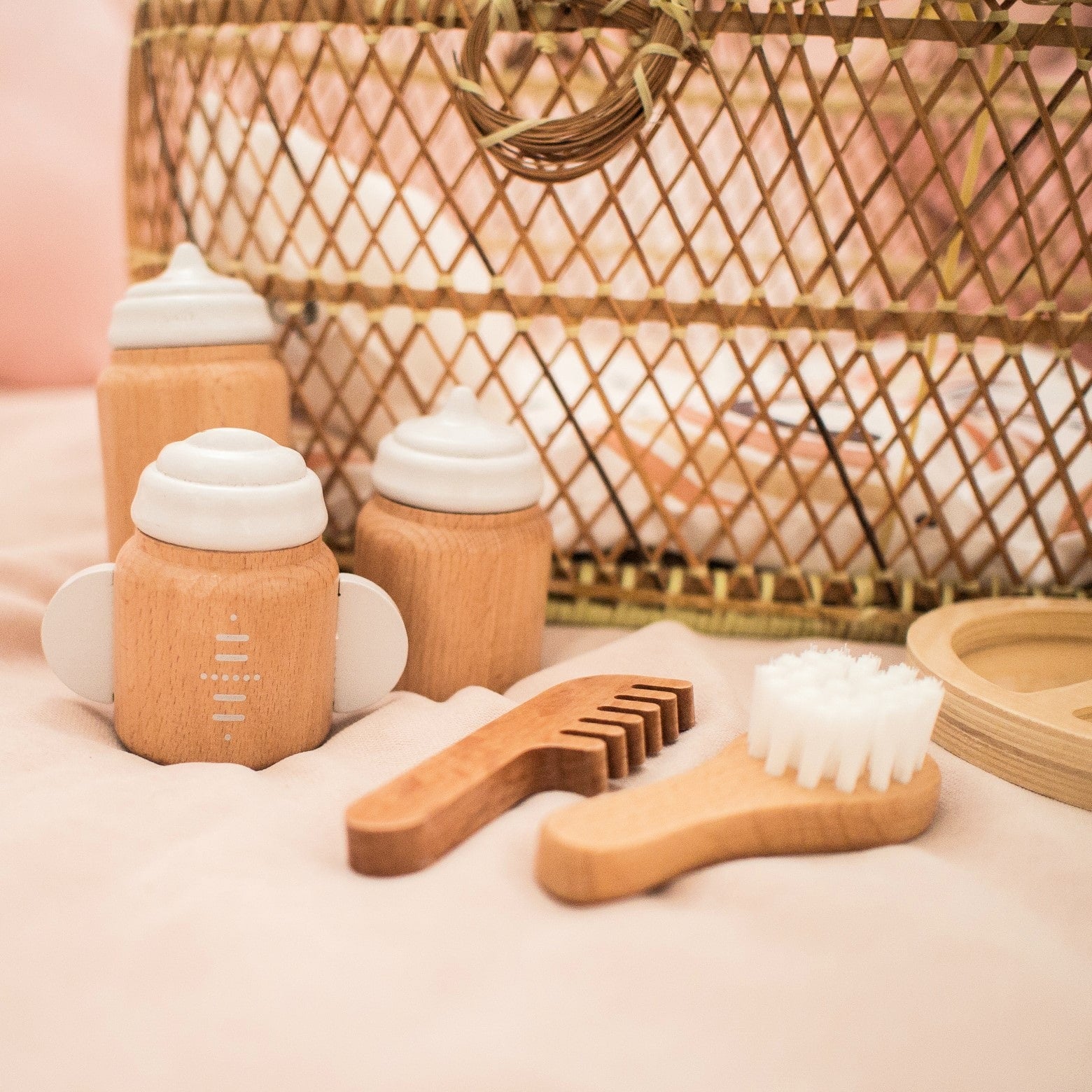 Make Me Iconic 11-piece wooden doll accessory kit with bottles, sippy cup, bowl, fork, spoon, brush with real bristles, comb, teether, and clip-on pacifier – perfect for pretend play.