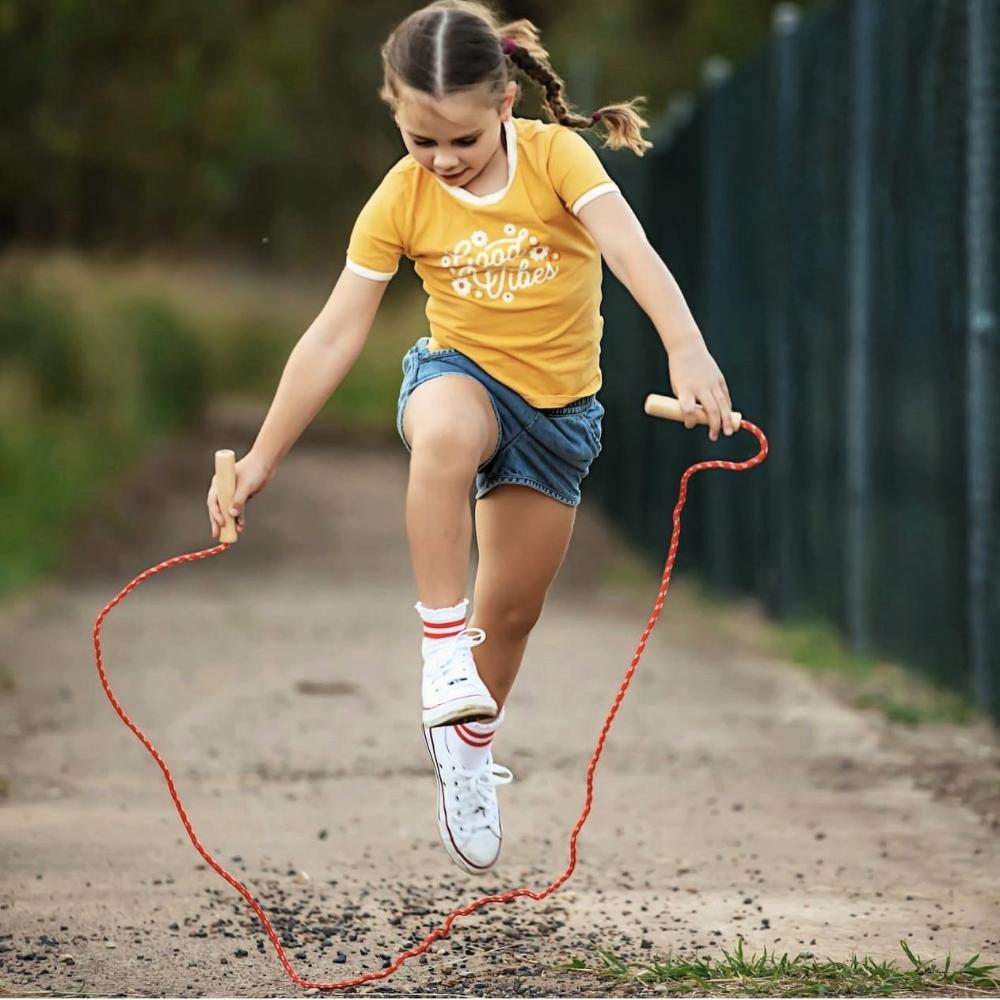 Make Me Iconic wooden skipping rope with smooth natural handles and red-coloured rope, designed for active play, coordination, and classic childhood fun.