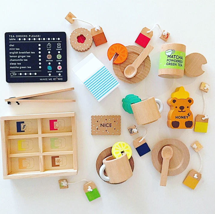 Make Me Iconic 27-piece wooden toy Tea Set Extension Set with tea cups, tea bags, tongs, cookies, and accessories. Ideal for pretend play and perfectly matched with our wooden toy Tea Set.