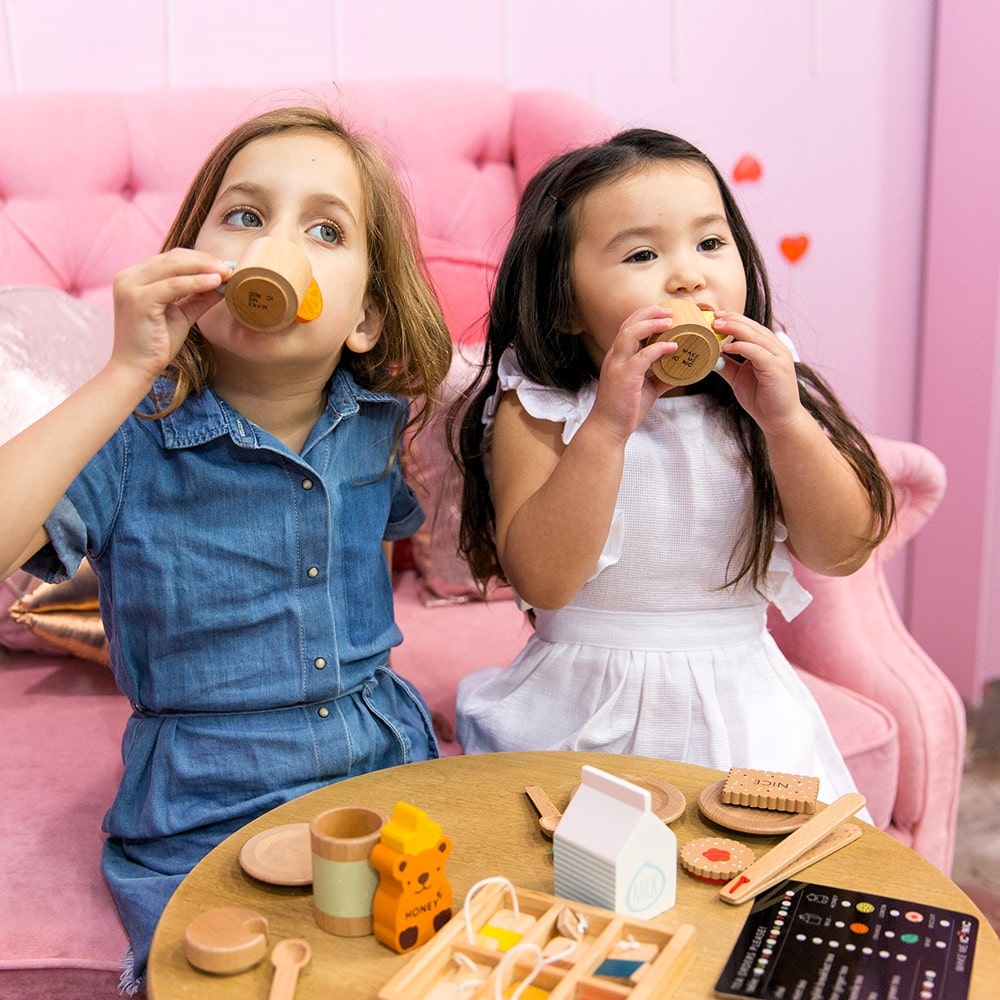 Make Me Iconic 27-piece wooden toy Tea Set Extension Set with tea cups, tea bags, tongs, cookies, and accessories. Ideal for pretend play and perfectly matched with our wooden toy Tea Set.