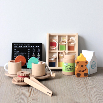 Make Me Iconic 27-piece wooden toy Tea Set Extension Set with tea cups, tea bags, tongs, cookies, and accessories. Ideal for pretend play and perfectly matched with our wooden toy Tea Set.