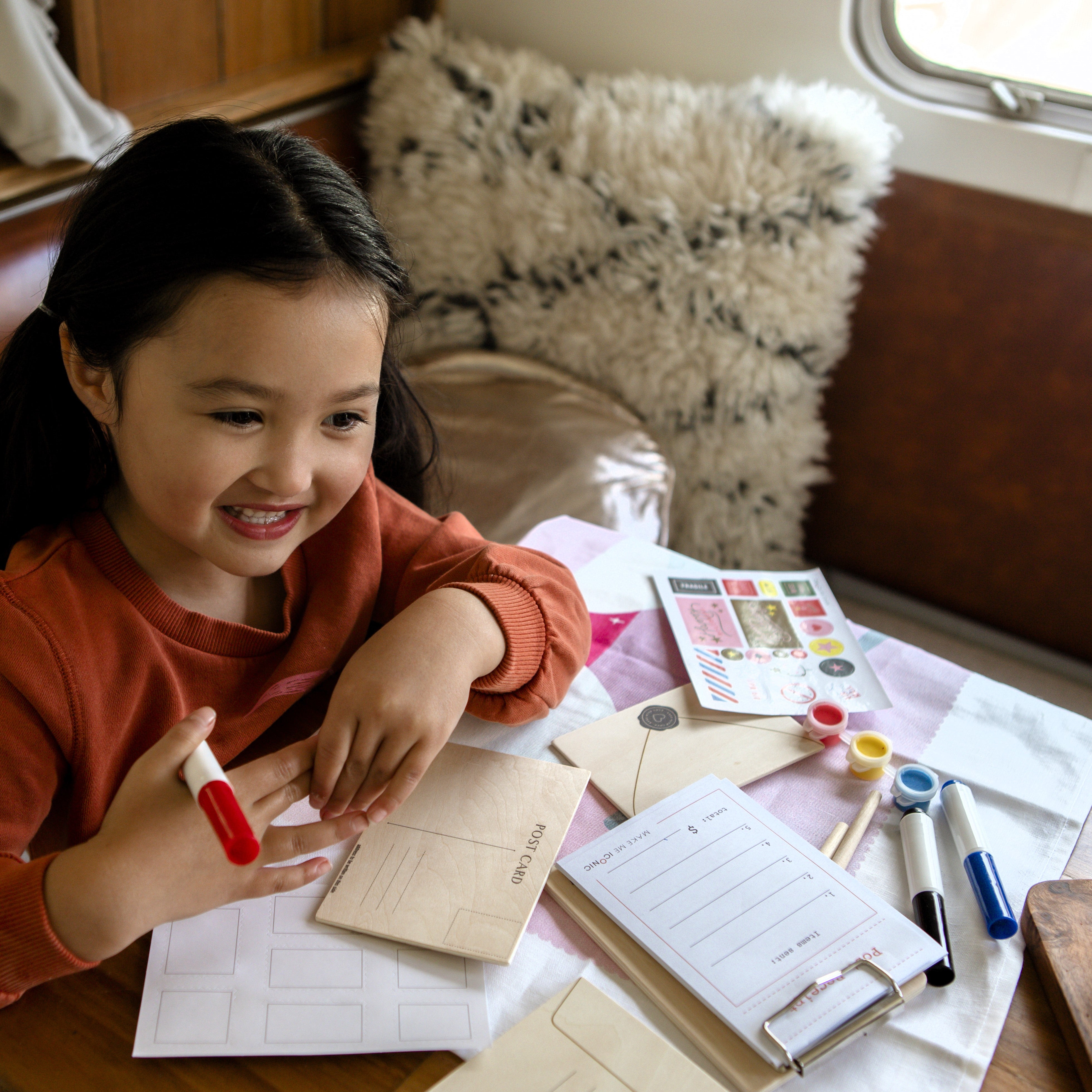 DIY Post Box Letters Craft Kit with colourful paper letters, stamps, and envelopes designed to pair with wooden toy Iconic Post Box for imaginative play.