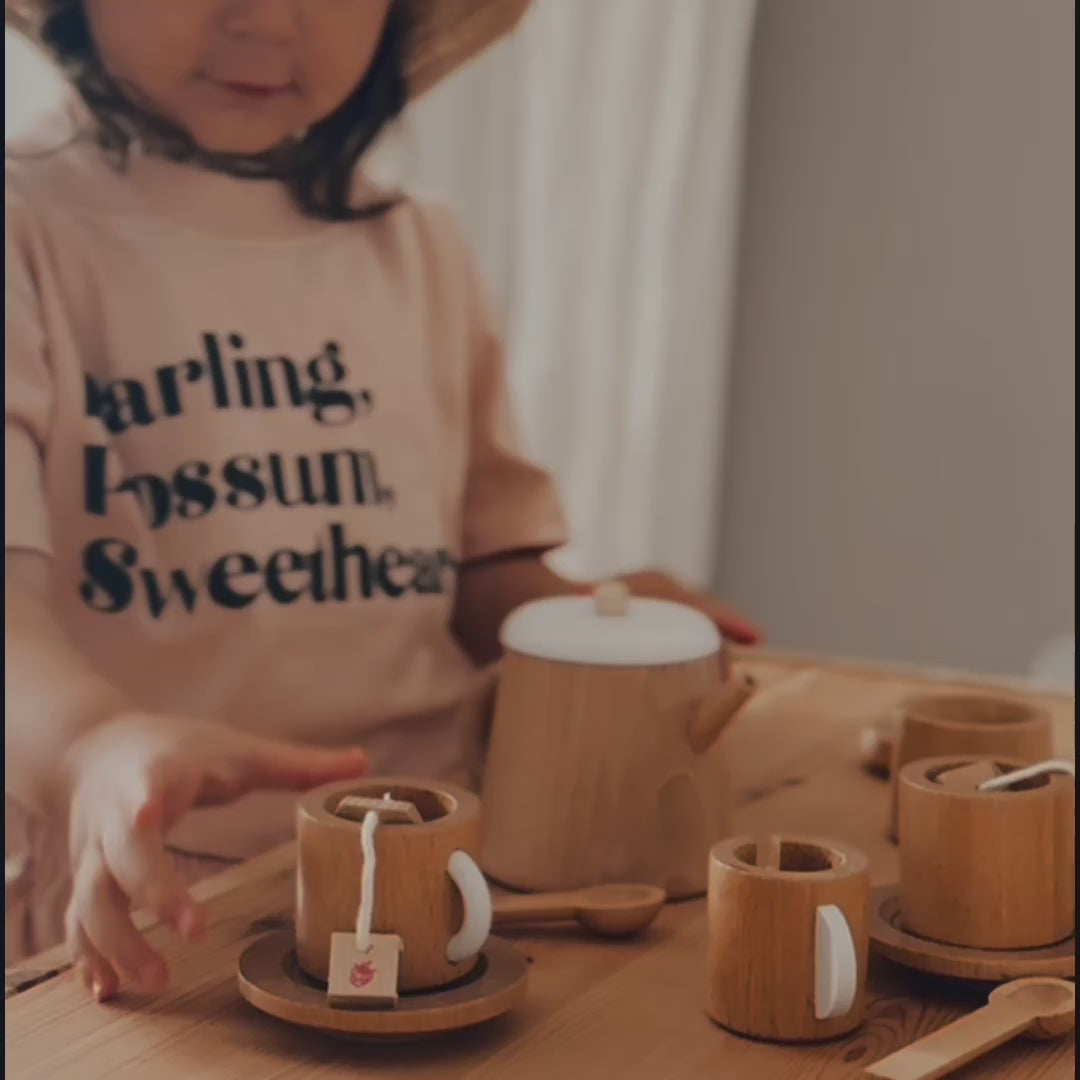 Make Me Iconic 18-piece wooden toy tea set with teapot, tea bags, sugar cubes, cups, saucers, and spoons, perfect for pretend tea parties and role play.