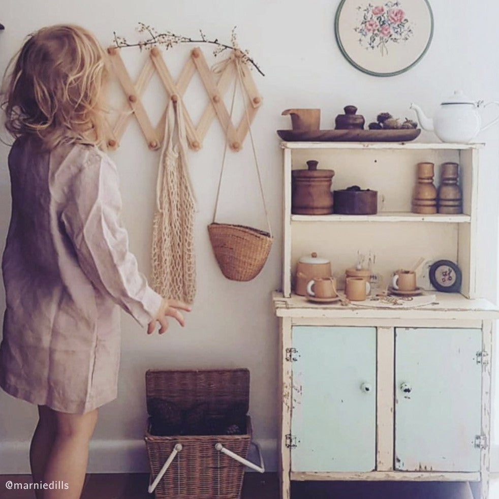 Kids play kitchen setup with wooden toys, accessories and neutral styling for imaginative play