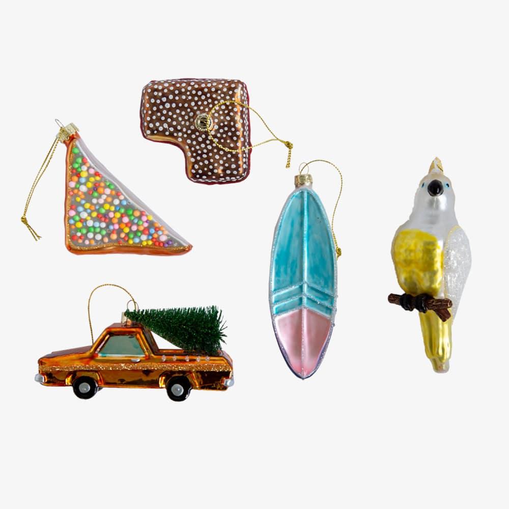 Make Me Iconic Christmas glass ornament set, 5-piece Australian-themed decorations featuring Fairy Bread, Lamington, Ute with tree, Surfboard, and Cockatoo, crafted in glass with paint and glitter details, great for gifts and Aussie souvenirs.