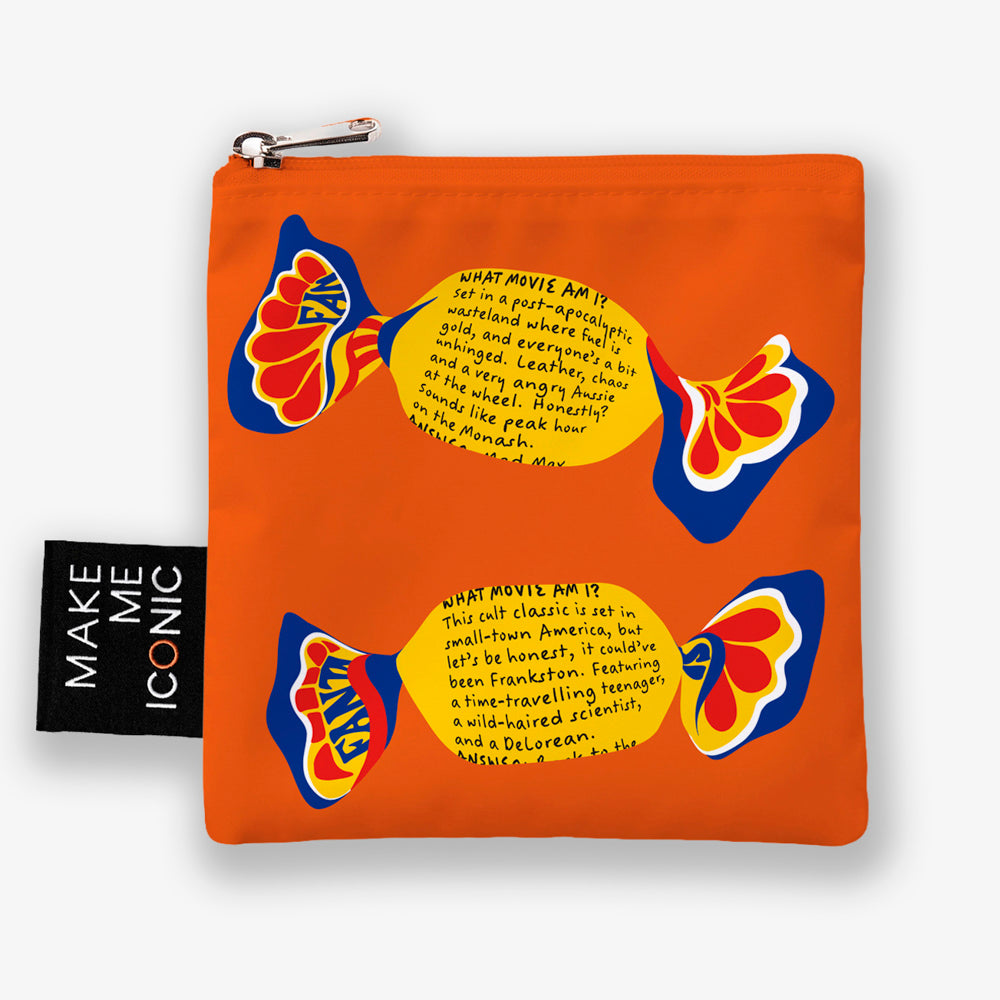 A Make Me Iconic reusable foldable shopping bag featuring a nostalgic Fantale lolly design on a vibrant orange background. Made from 100% recycled fabric, this lightweight bag folds into its own matching pouch, making it perfect for shopping, travel, or everyday use while celebrating one of Australia's most iconic treats.