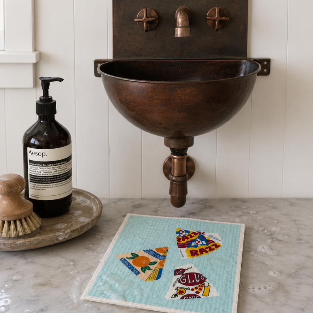 A Make Me Iconic reusable Swedish dishcloth featuring illustrations of three iconic Australian frozen treats: Bubble O' Bill, Golden Gaytime and Sunnyboy. The eco-friendly sponge has a nostalgic Aussie ice cream design in bright colours, making it a fun and practical kitchen cleaning cloth for everyday use.