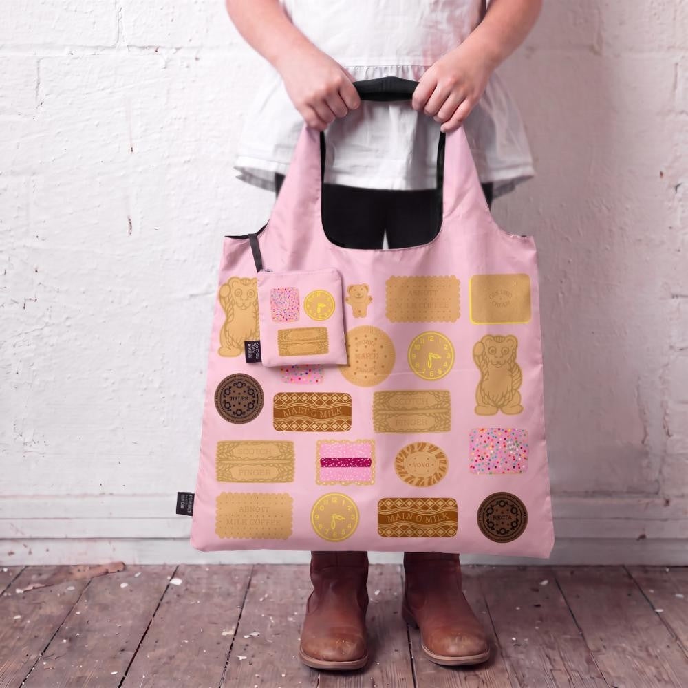 A Make Me Iconic reusable foldable shopping bag featuring nostalgic Arnott’s Bickies on a playful pink background. Made from 100% recycled fabric, this lightweight bag folds into its own matching pouch, making it perfect for shopping, travel, or everyday use while celebrating some of Australia’s most iconic biscuits.