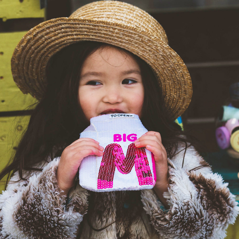 Big M Pocket Purse inspired by the iconic Aussie strawberry milk drink. Featuring shimmering sequins, it's perfect for coins, keys and little treasures.