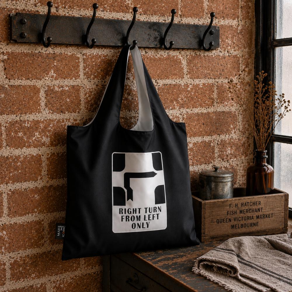 A Make Me Iconic reusable foldable shopping bag featuring Melbourne's iconic Hook Turn road sign. Made from 100% recycled fabric, this lightweight eco-friendly tote folds into a compact pouch and holds up to 20kg for everyday shopping