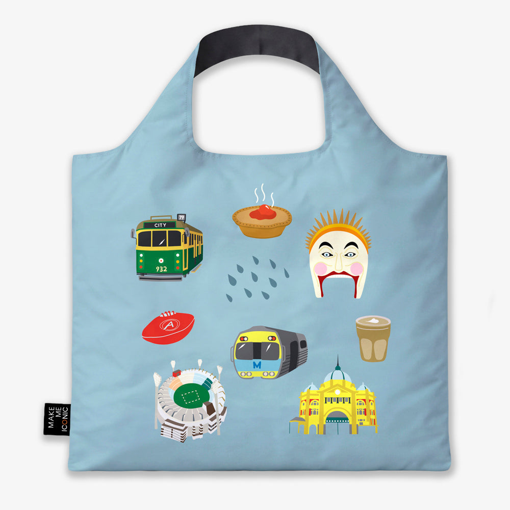 A Make Me Iconic reusable foldable shopping bag featuring iconic Melbourne landmarks and symbols including a W-Class tram, MCG, Flinders Street Station, coffee, meat pie, rain, and AFL football. Made from 100% recycled fabric, this lightweight eco-friendly tote folds into a compact pouch for shopping, travel, and everyday use.