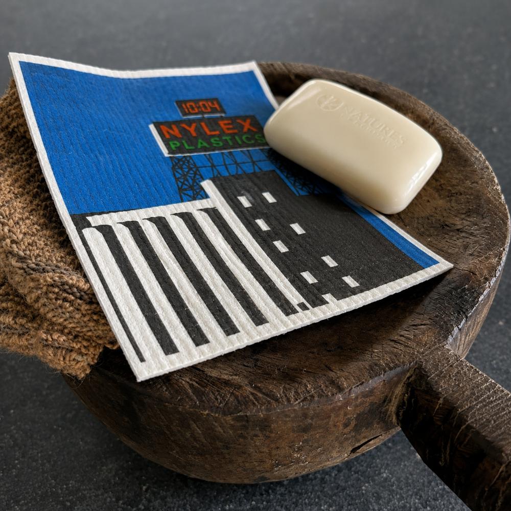 Inspired by Melbourne’s iconic Skipping Girl and Nylex Plastics signs, this Swedish dish cloth celebrates two beloved landmarks that have lit up the city skyline for generations. Made from natural fibres, it’s durable, reusable, super absorbent, and designed to bring a nostalgic touch of everyday Melbourne life into your kitchen while making cleaning a little more fun.