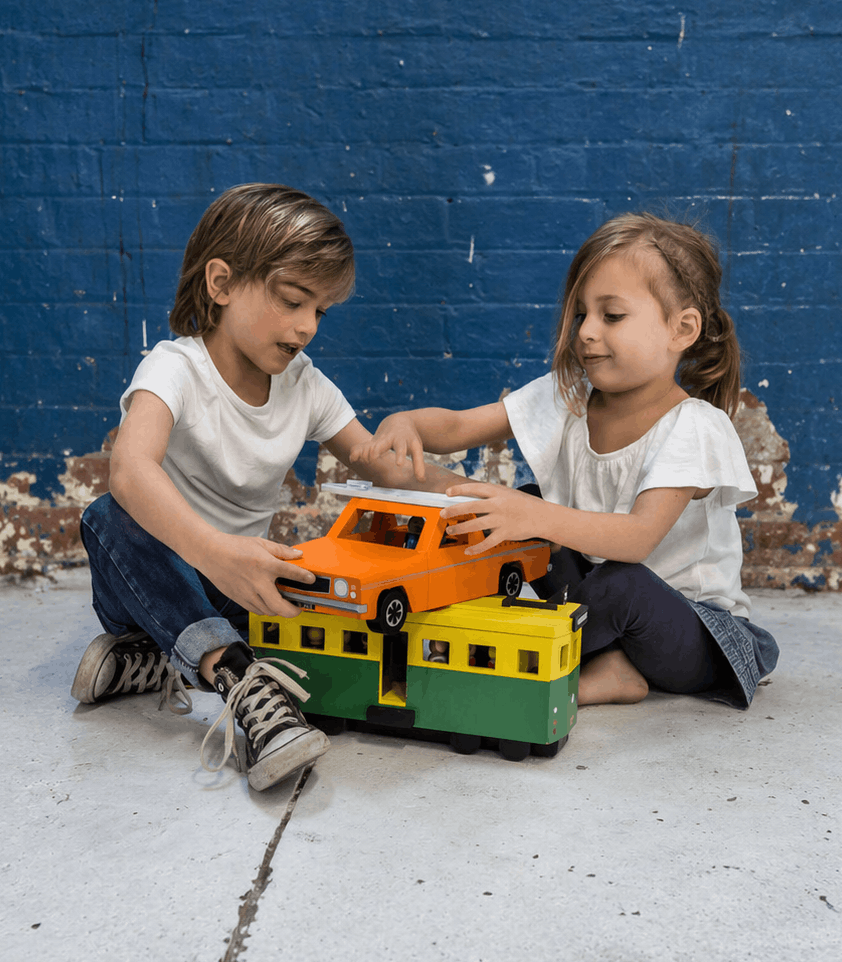 Children engaged in play-based learning with wooden toy vehicles, ideal for schools, kinders and early childhood education programs