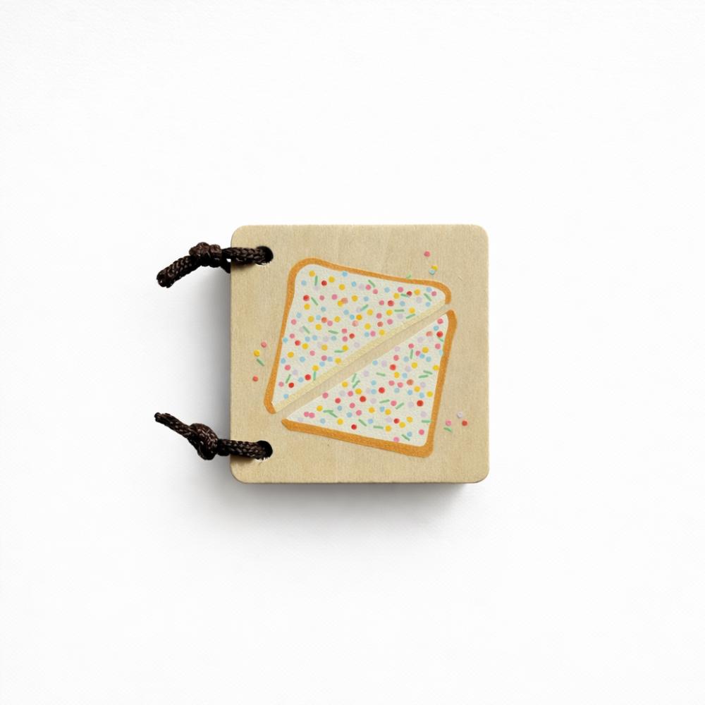Make Me Iconic Iconic Australian Favourites mini wooden book for toddlers, featuring Aussie icons including fairy bread, Ugg boots, surfboards and beach days for early learning, word recognition and screen-free play.