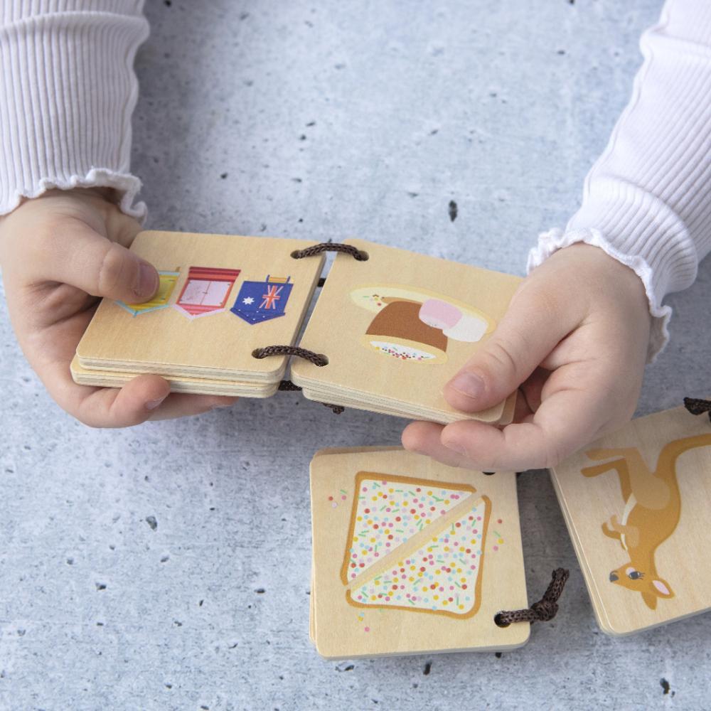 Make Me Iconic Iconic Australian Favourites mini wooden book for toddlers, featuring Aussie icons including fairy bread, Ugg boots, surfboards and beach days for early learning, word recognition and screen-free play.