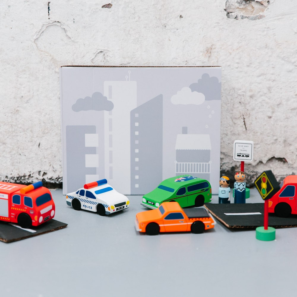 Aussie wooden toy vehicle set featuring Sandman Panel Van, retro-orange ute, fire truck, and postie bike for imaginative play