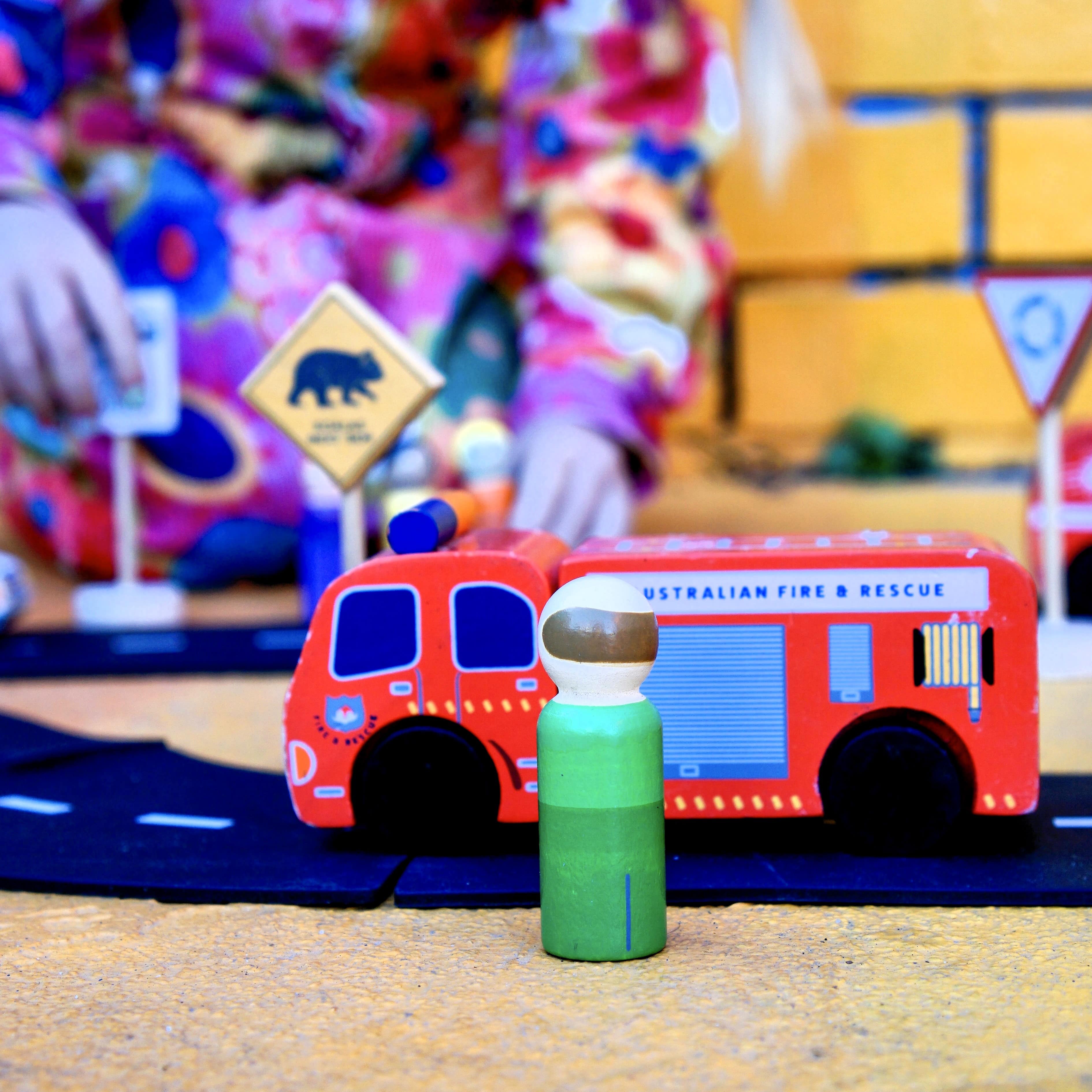 Aussie wooden toy vehicle set featuring Sandman Panel Van, retro-orange ute, fire truck, and postie bike for imaginative play