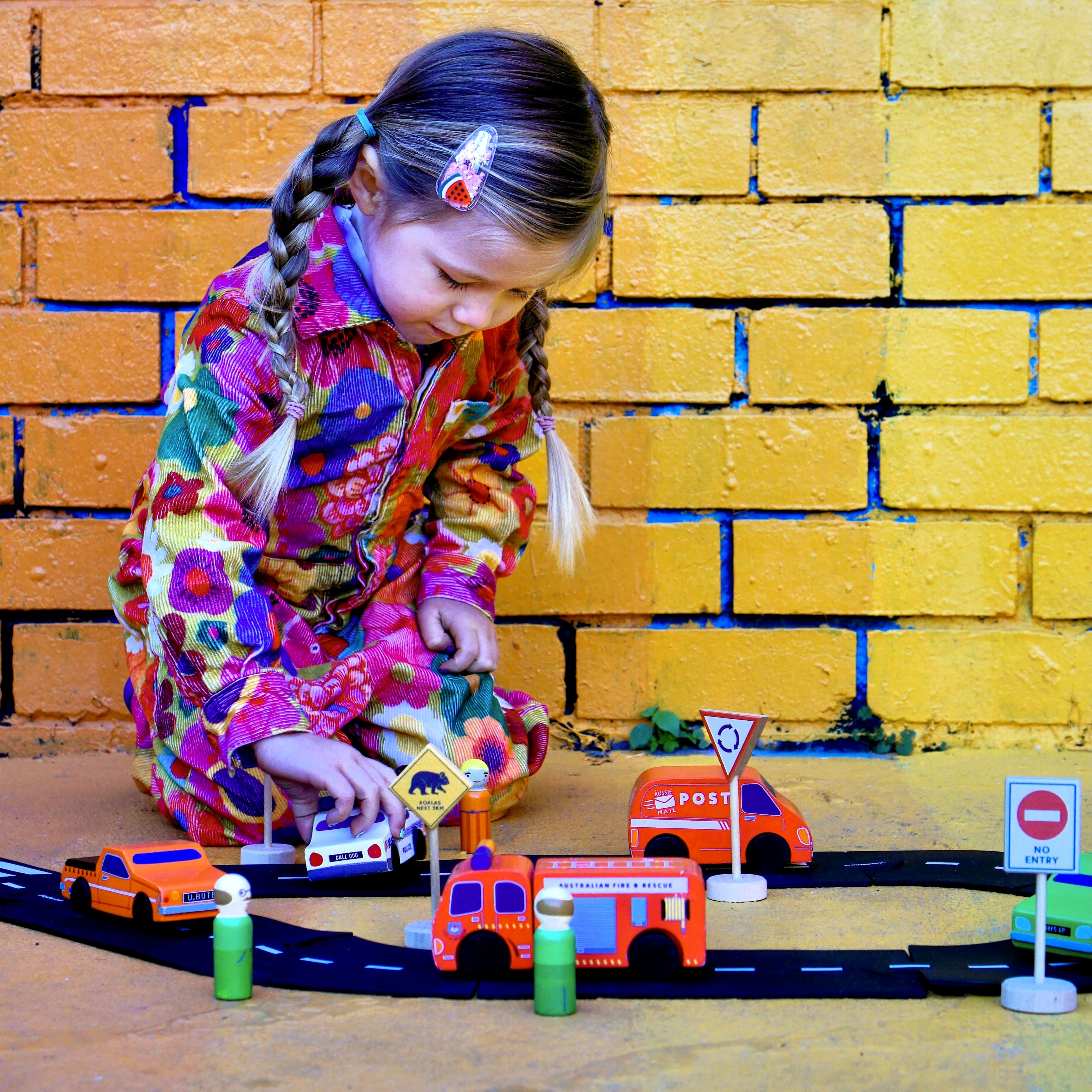 Aussie wooden toy vehicle set featuring Sandman Panel Van, retro-orange ute, fire truck, and postie bike for imaginative play