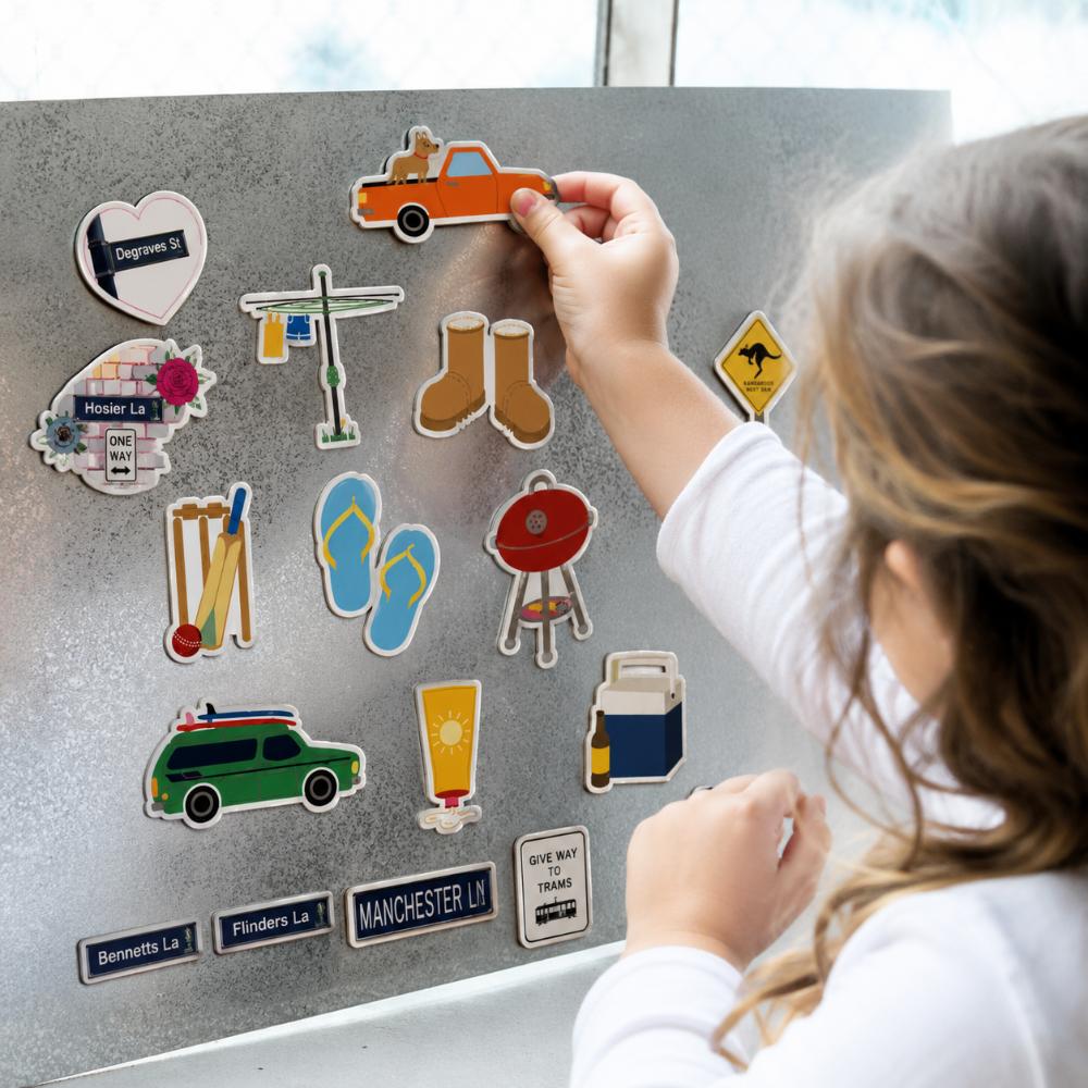 Australian icons fridge magnet set featuring a ute, Hills Hoist, thongs, cricket, BBQ, footy, Akubra-style hat, boots, sunscreen and Esky.