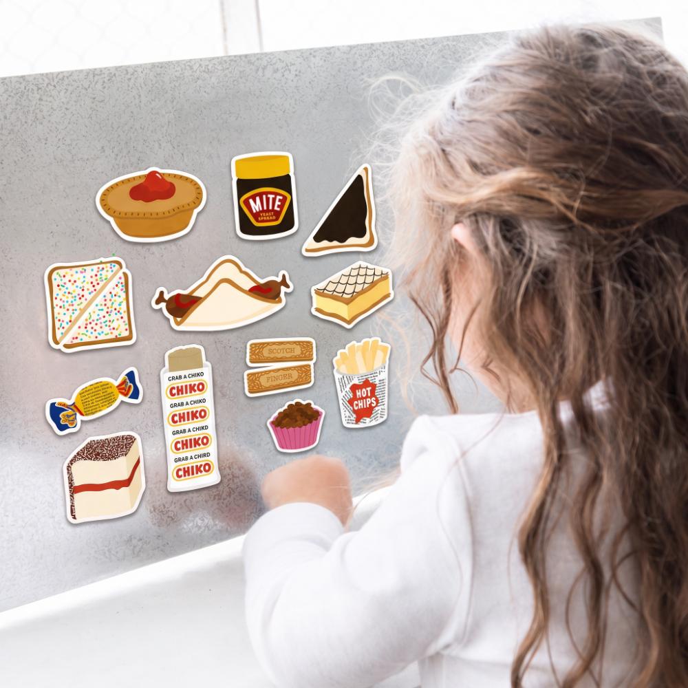 Make Me Iconic Australian Snack Fridge Magnet Set featuring colourful retro food magnets inspired by nostalgic Aussie favourites, including Fairy Bread, Fantales, Chiko Rolls, meat pies, sausage sizzles, hot chips, lamingtons and Scotch Finger biscuits. These playful Australian food magnets add a touch of nostalgia to your fridge while holding kids’ artwork, shopping lists, photos and reminders. A fun Australian souvenir, unique gift idea and retro kitchen accessory celebrating iconic Australian snacks and 