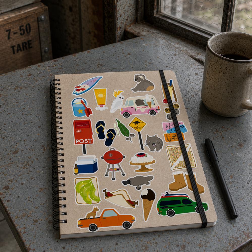 Two-sheet Aussie Icons Sticker Set in clear retail packaging featuring colourful Australian icons including Fairy Bread, kangaroo, koala, ute, BBQ, pavlova, post box, beach gear, ice cream van, cricket, thongs, coins and other nostalgic Australian favourites.