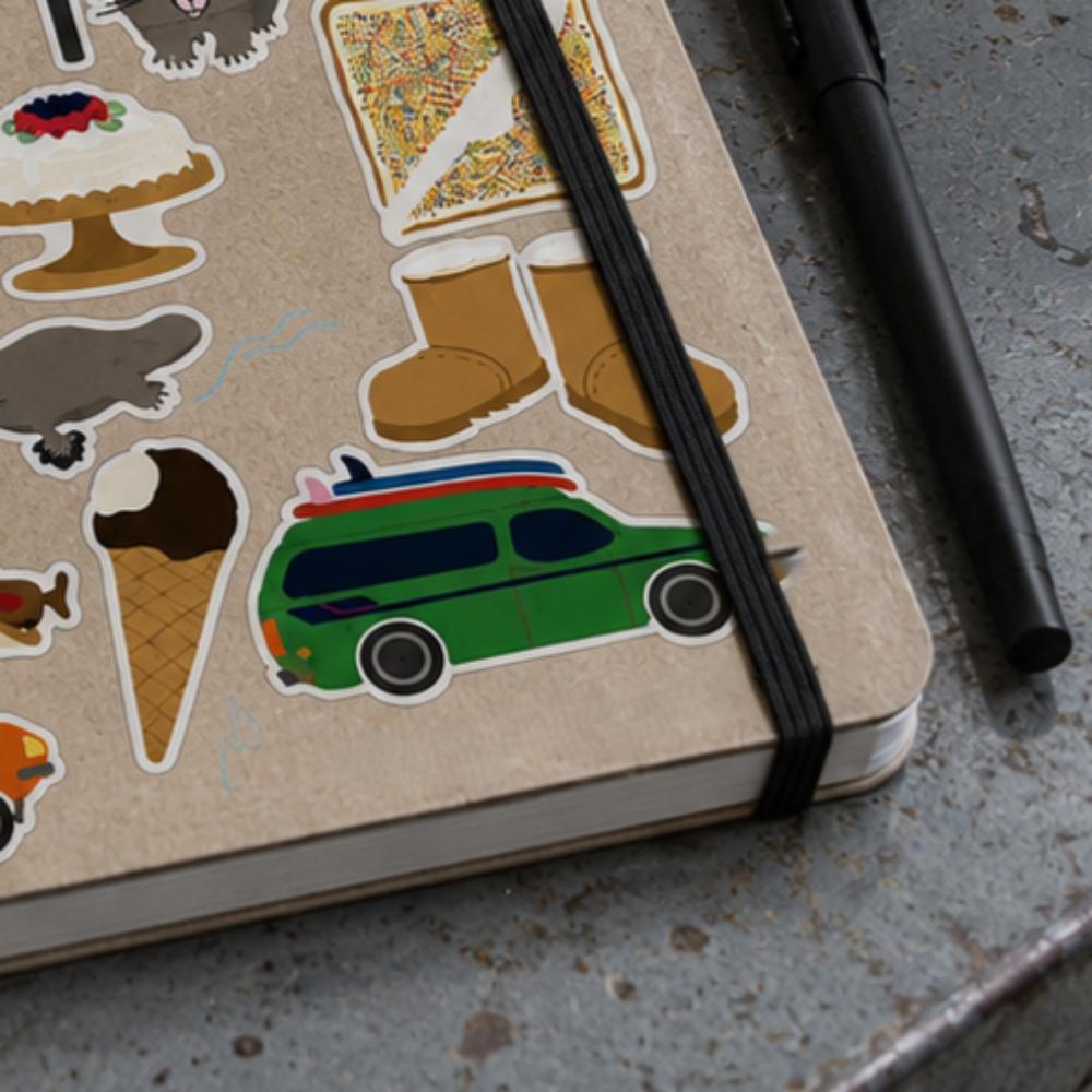 Two-sheet Aussie Icons Sticker Set in clear retail packaging featuring colourful Australian icons including Fairy Bread, kangaroo, koala, ute, BBQ, pavlova, post box, beach gear, ice cream van, cricket, thongs, coins and other nostalgic Australian favourites.