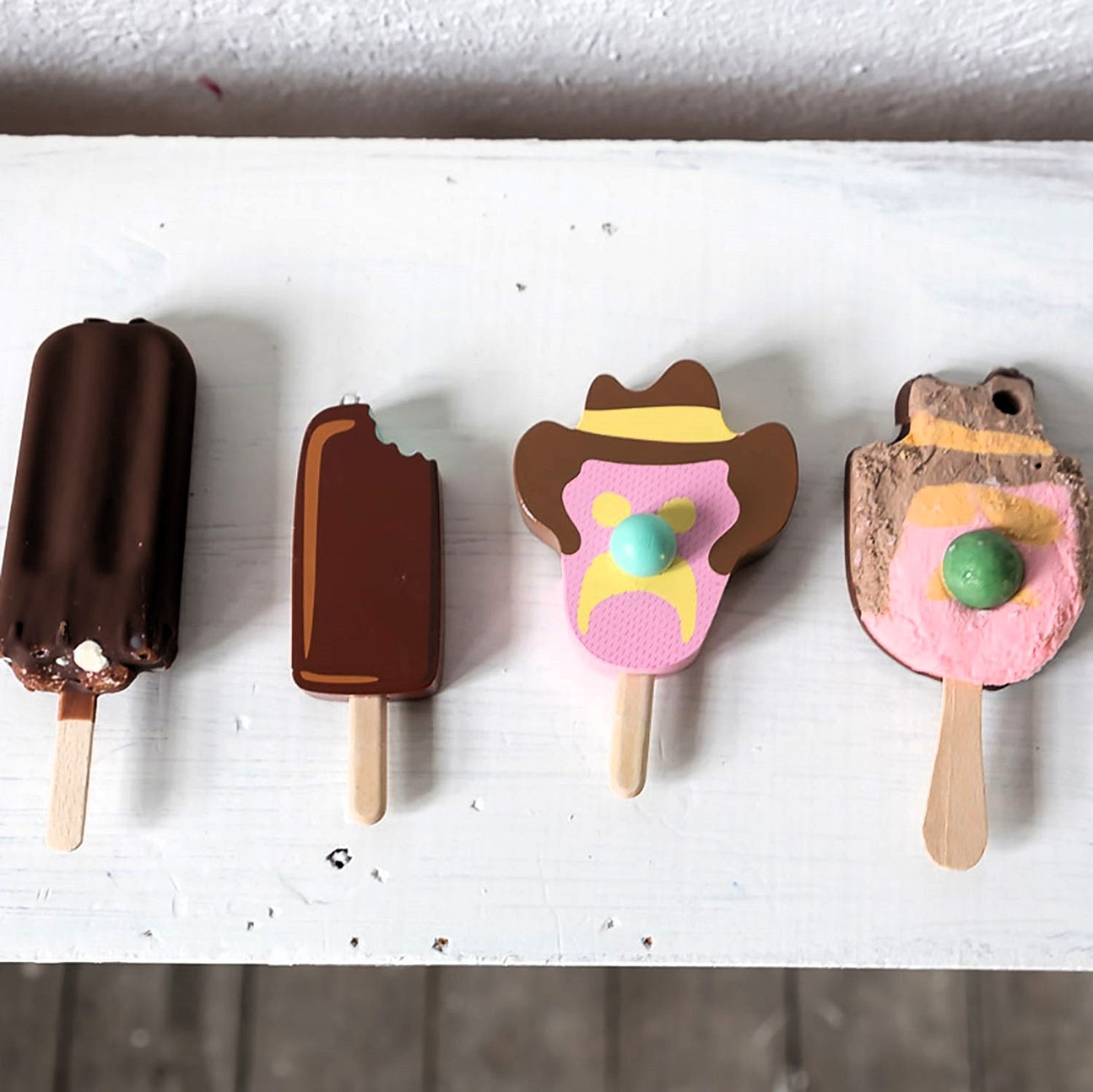 Wooden toy ice cream set with Bubble O’ Bill, Golden Gaytime, Mint Choc Wedge, Rainbow Paddle Pop, wooden stand and paper bags for pretend play.
