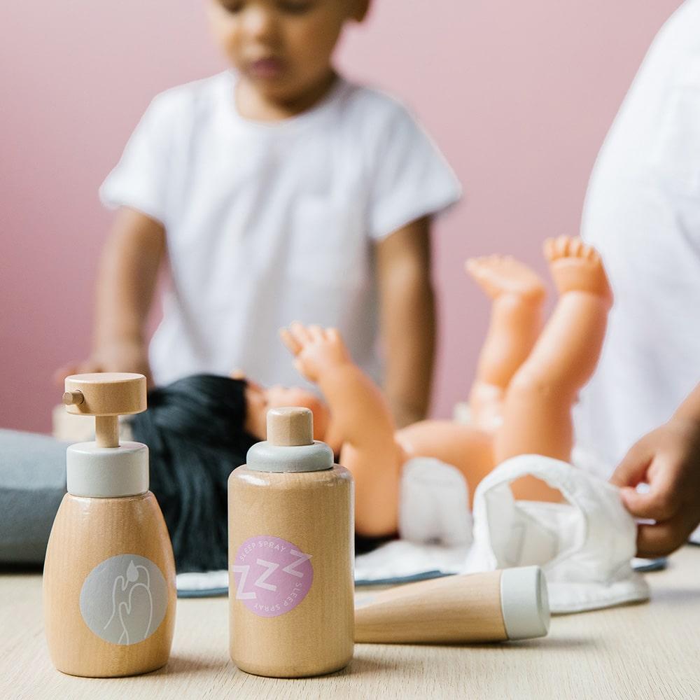 Wooden toy Doll Nurturing Kit made of wood and fabric for kids with potty, wipes, nappies, and accessories designed for pretend play, nurturing, and hands-on role-play activities.
