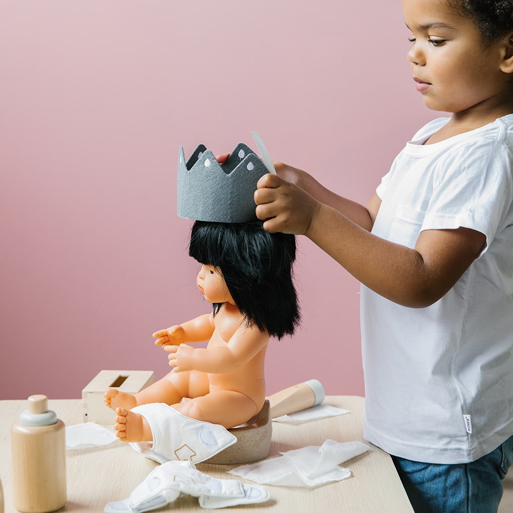 Wooden toy Doll Nurturing Kit made of wood and fabric for kids with potty, wipes, nappies, and accessories designed for pretend play, nurturing, and hands-on role-play activities.