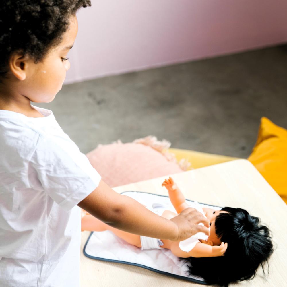 Wooden toy Doll Nurturing Kit made of wood and fabric for kids with potty, wipes, nappies, and accessories designed for pretend play, nurturing, and hands-on role-play activities.