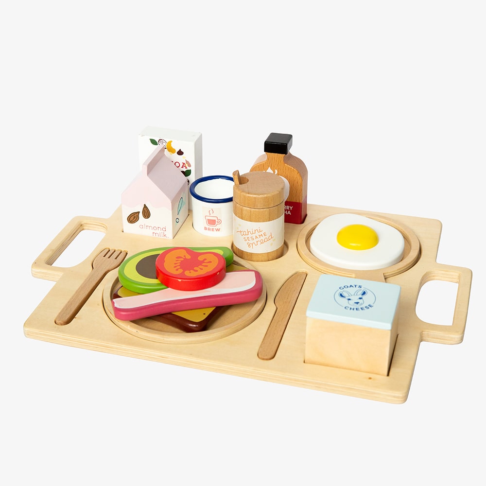 21-piece wooden toy breakfast tray featuring avocado on toast, goats cheese, tahini, kombucha, and other café-style foods for pretend play fun.