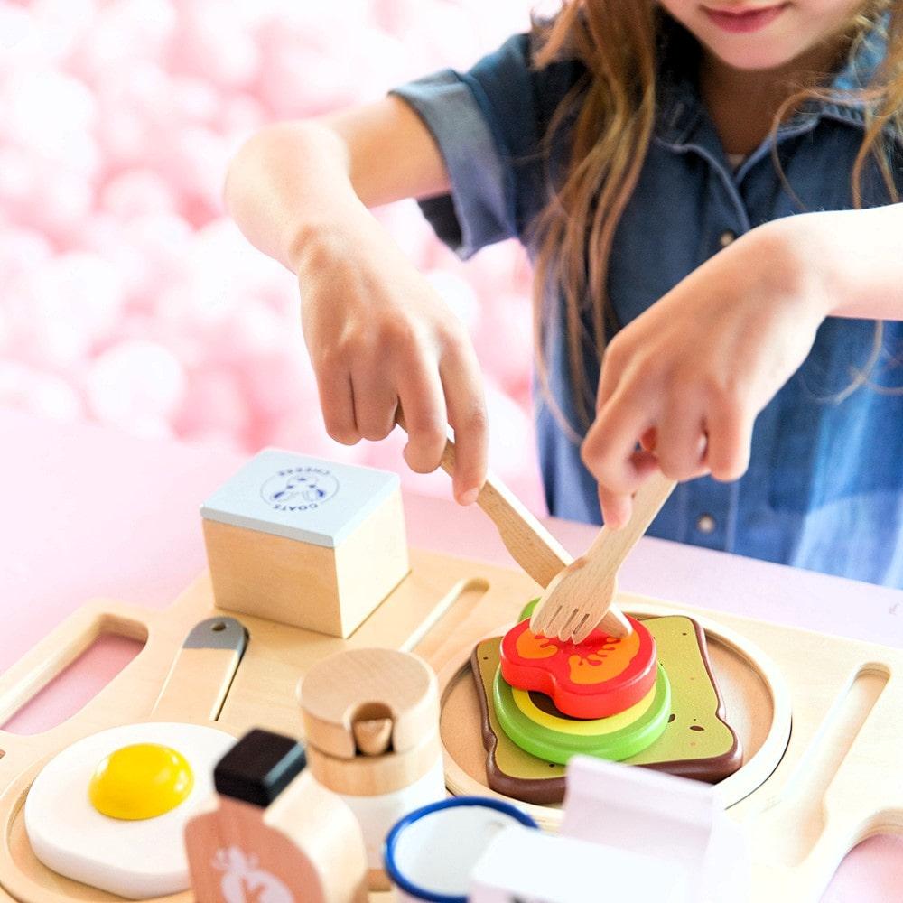 Make Me Iconic wooden Healthy Tummy Brekkie or Breakfast Tray featuring toy avocado toast, kombucha, almond milk, goat's cheese, and tahini spread. A 21-piece wooden breakfast play set inspired by Aussie café culture, perfect for pretend play, creativity, and healthy food learning.